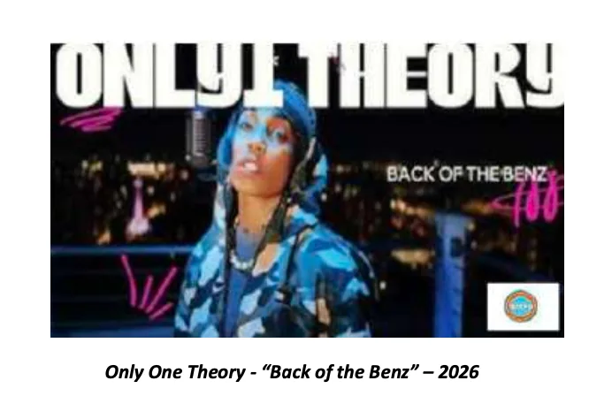 Still from Back of the Benz — a performer in a blue camo hooded jacket at a studio microphone against a night cityscape.